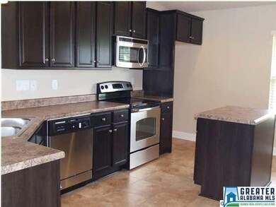 KITCHEN WITH PLENTY OF COUNTER SPACE AND CABINETS