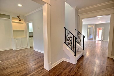 Front entry hall with wrought iron stairs leading 