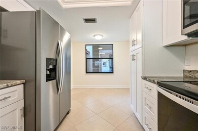 Kitchen with stainless steel appliances, white cab