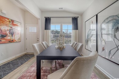 Dining space with lofted ceiling, wood finished fl