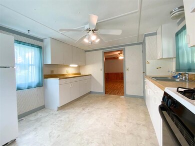 This home boasts a spacious kitchen with many cabi