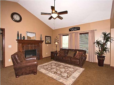 Living room features a vaulted ceiling and windows