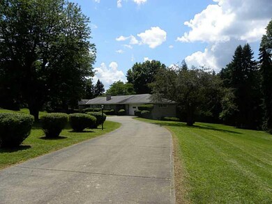 Exterior Front. Long driveway leading up to the ho