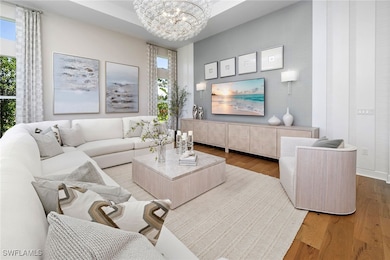 Living area with a chandelier, plenty of natural l