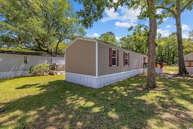 View of side of home featuring a yard