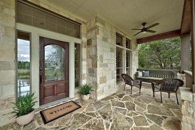Property entrance with covered porch, a ceiling f