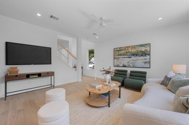 Living room featuring light wood-style floors, st