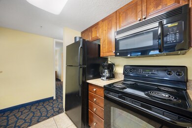 Kitchen featuring light tile patterned flooring an