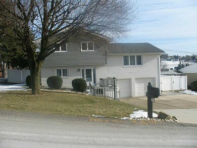 Exterior Front. In full bloom, the mature tree is 