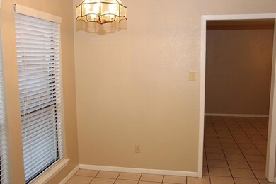 Unfurnished room featuring light tile patterned f