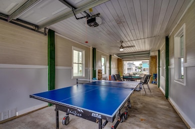 Game room featuring concrete floors and baseboards
