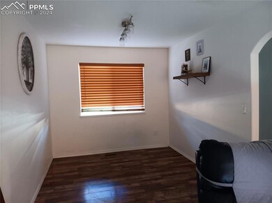 Unfurnished office featuring dark wood-type floori