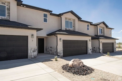 View of front of property with stone siding, stucco siding, and driveway