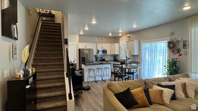 Living area with stairway, light wood-style floors, and recessed lighting