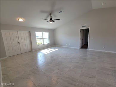 Unfurnished room featuring ceiling fan and lofted