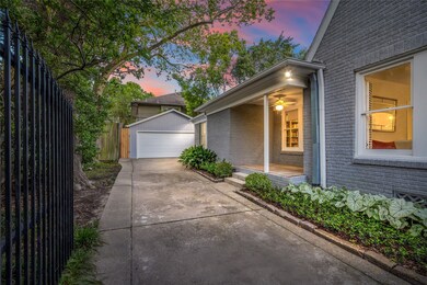 Gated driveway leading to a two car garage