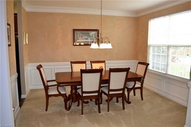Dining room has plenty of room for a china cabinet or buffet and great natural light