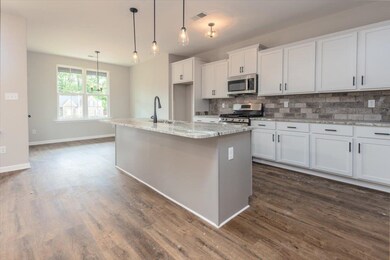 Kitchen with visible vents, dark wood-style floori