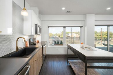 Kitchen featuring dark wood finished floors, tast