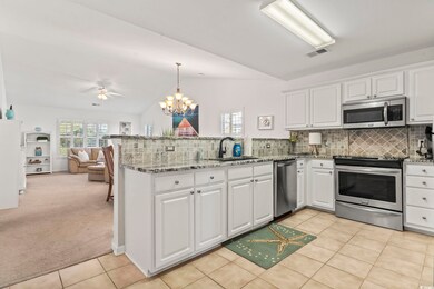 Kitchen featuring white cabinets, stainless steel 