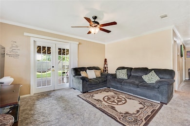Living area with french doors, carpet, a ceiling f