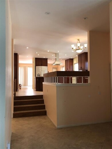 Up a few steps to an open concept kitchen and dini