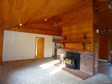 Large brick fireplace hosts coal burning insert in