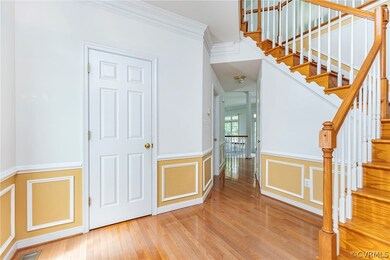 Staircase featuring ornamental molding and light w