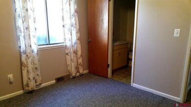 This bedroom has a small bathroom + laundry