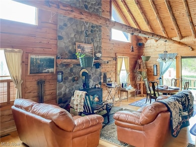 Living room with light hardwood / wood-style floors and a wood stove