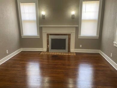 Unfurnished living room featuring a fireplace, a h