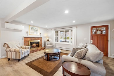 Entry to living room with wood burning fp