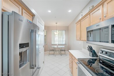 Kitchen featuring pendant lighting, light tile pat
