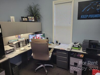 Desk pictured remains in office; beige chair does not.
