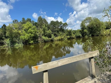 Dock area featuring a water view and a wooded view