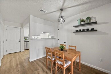 Dining space featuring a textured ceiling and ligh