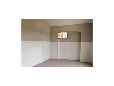 Formal dining with beautiful wainscoting and hutch