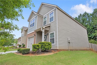 View of property exterior featuring an attached garage and brick siding
