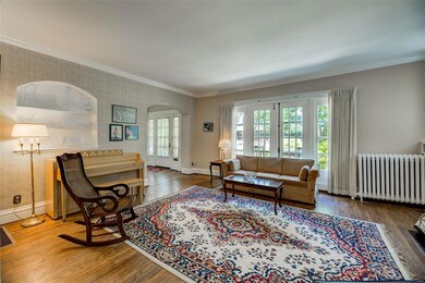 The living room has crown molding and pretty wood 
