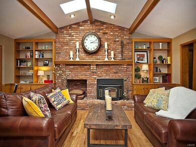 Stunning brick fireplace with skylights.