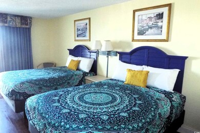Bedroom with a textured ceiling and hardwood / woo