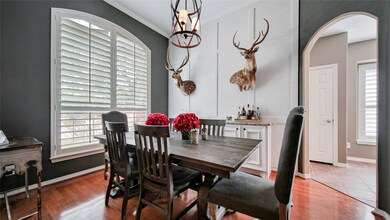 A great view of the wood paneling on the wall and the cased archways leading into the kitchen.