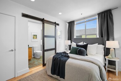 The loft bedroom has metal railings & overlooks the main floor living space. There are recessed lights, curtains and mini-blinds, an ensuite bath and walk-in closet. Wood floors.