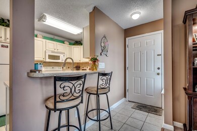 Kitchen featuring a textured ceiling, sink, light 