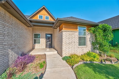 Entrance to property featuring brick siding and a yard