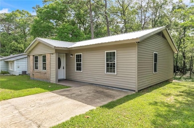 Single story home with a patio, a front lawn, and 