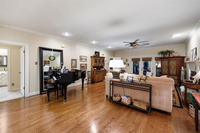 Living area featuring ceiling fan, ornamental mol