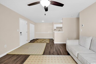 Unfurnished living room with dark wood finished floors, ceiling fan, and recessed lighting