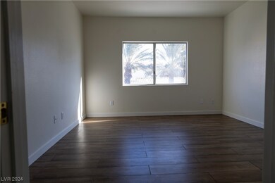 The primary bedroom has a large window that faces