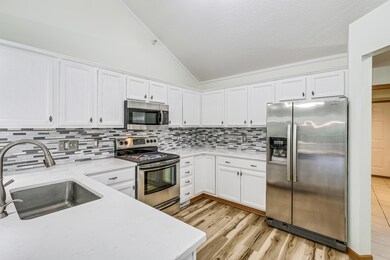 Enjoy Beautiful updated kitchen with quartz countertops, glass backsplash and SS Appliances